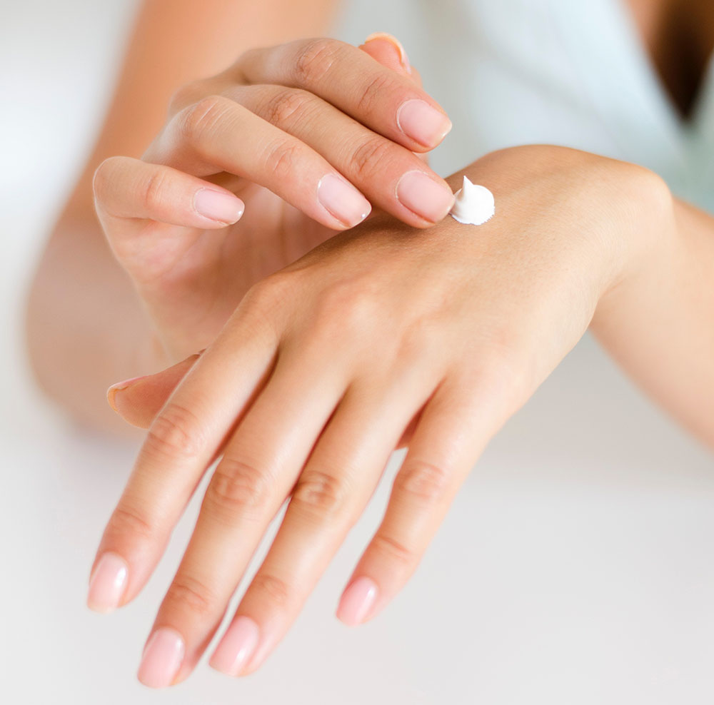 Person applying lotion to hands image