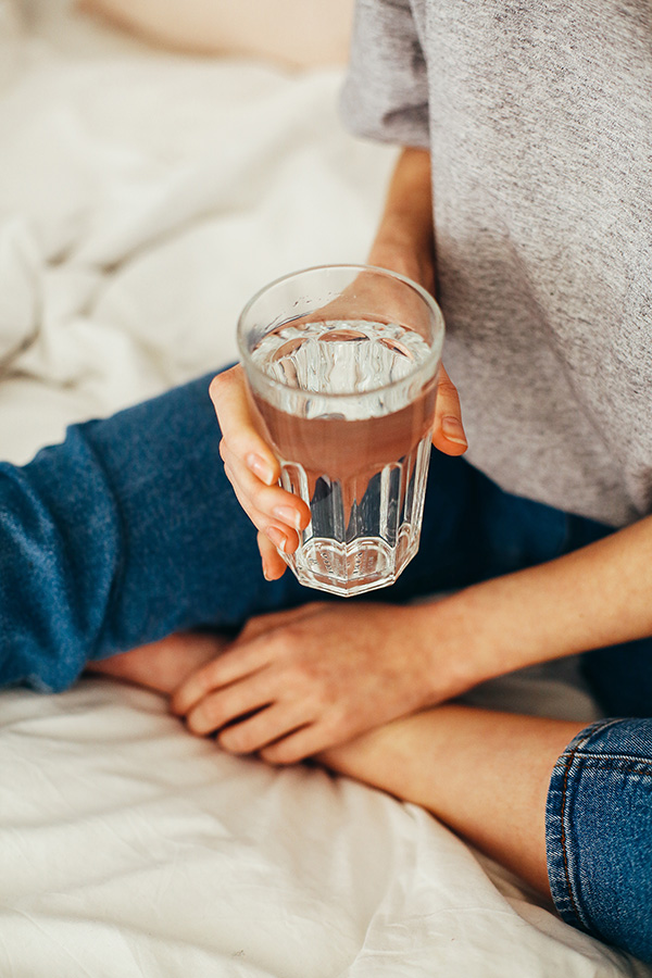 Person holding a glass of water image